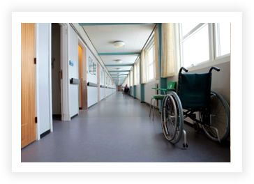 Looking down a hospital hallway with a wheelchair sitting to the side